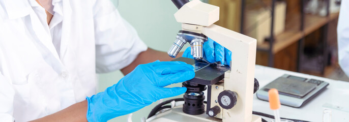 Banner Scientist man look Microscope research in science laboratory. Banner Asian scientist use...