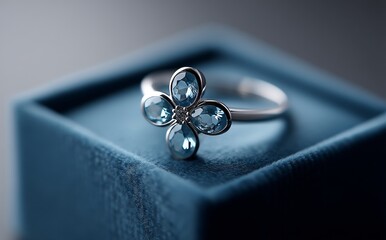 The brooch, adorned with clear gems, lies on a luxurious blue velvet jewelry box, creating an elegant and refined display
