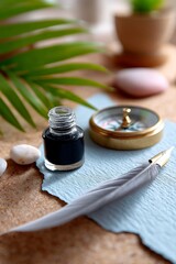 Vintage ink bottle with feather quill and compass on textured blue paper