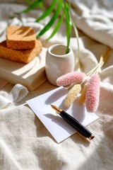 Elegant workspace with fountain pen, envelopes, and natural decorations on linen fabric