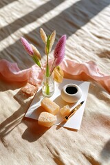 Cozy home workspace with vase, pampas grass, ink pot, pen, and natural sponges in sunlight