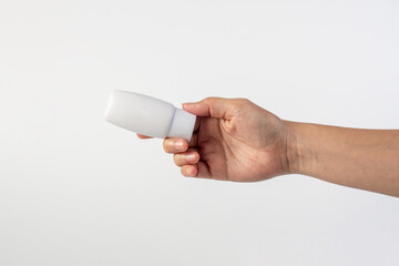 Skin care or sunscreen cosmetic and hand on white background.