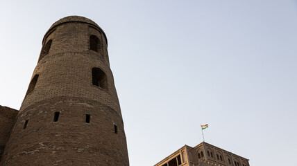 An AweInspiring Ancient Fortress Tower Standing Majestically Under a Clear Blue Sky