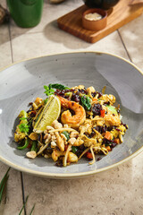 Wok-fried wild rice with vegetables, egg, and shrimp under bright natural lighting, overhead composition