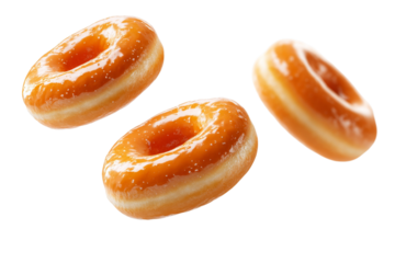 Three donuts in the air, one of which is a glazed donut