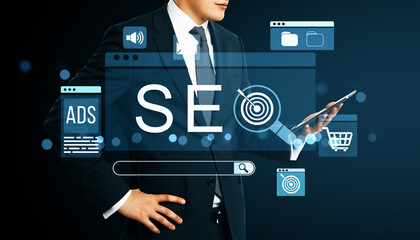 Businessman using tablet with SEO interface icons representing digital marketing, search engine...