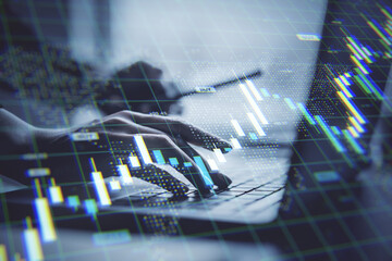 Person using laptop with financial chart overlay on screen representing forex trading, investment analysis, and digital stock market data concept.