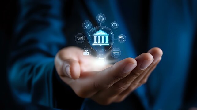Digital banking concept with glowing hologram icons floating above businessman's palm showing financial technology and online banking services in blue tones.