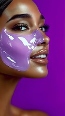 Young African American woman wearing purple glossy face mask against vibrant purple background, showcasing glowing skin, long lashes and glossy lips in profile view.
