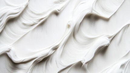 Obraz premium Creamy texture of white moisturizer or skincare product on a surface for beauty and wellness, cosmetic background with soft waves and smooth lines.