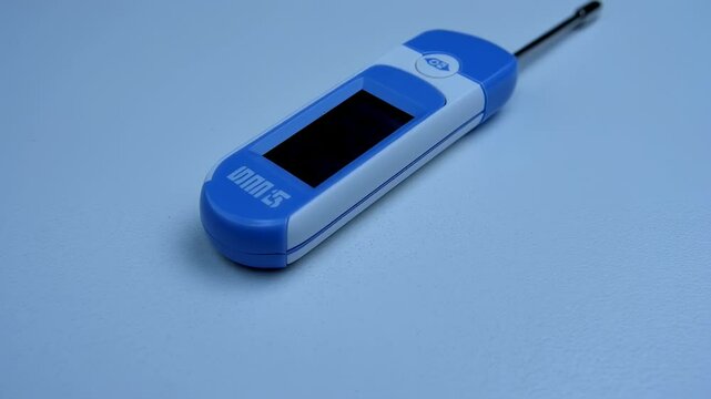 Electronic thermometer showcasing its digital display and temperature probe sensor