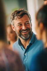 Fototapeta premium Man smiling during social gathering with friends, enjoying conversation and laughter, showcasing positive mood and connection in casual setting.