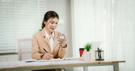 Asian businesswoman working from office with style, determination and self-confidence, using...