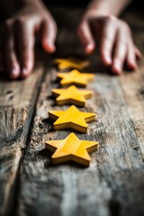 Hands arranging wooden star shapes on a rustic table, symbolizing success, achievement, feedback, and customer satisfaction in business and reviews.