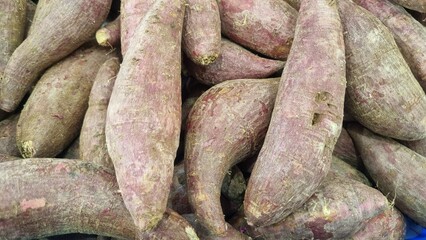 Organic raw purple sweet potatoes from local farmer market in basket. Sweet Potato (Ipomoea batatas), ubi, purple yam good source of antioxidants, particularly anthocyanins, which are linked to variou