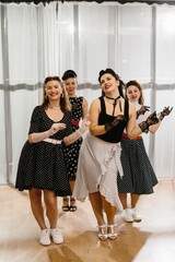 Four pinup dancers wearing polka dots are performing a choreography