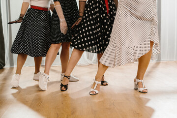 Women wearing polka dot dresses and dancing 1950s style