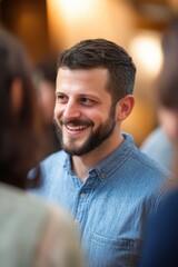 Obraz premium Man smiling during social gathering with friends, happy atmosphere, enjoying conversation, casual event, building connections, friendship, relaxation, lifestyle.