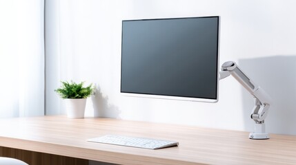 Modern workspace featuring a sleek monitor on an adjustable arm with a minimalist desk setup