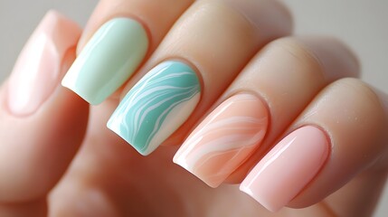 Nails painted in shades of blue and green to represen