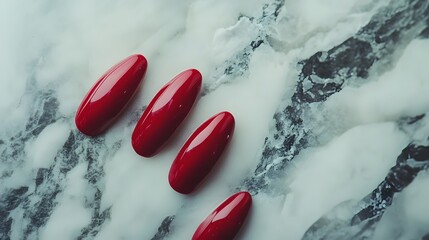 Nails painted in a vibrant shade of red resting 
