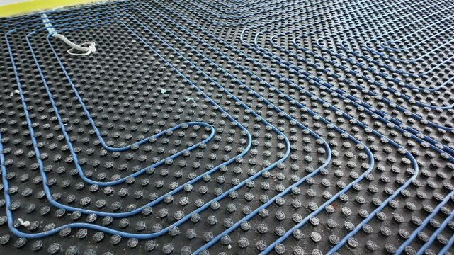 Modern Underfloor Heating System Installation. Energy-Efficient Radiant Floor Comfort and Renovation. Modern heating system in a new home