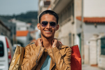 young man shopping with bags on the street