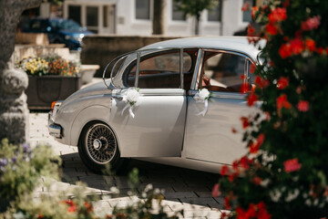 Decorated oldtimer wedding car parked near a Bavarian village ready for a romantic ceremony