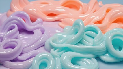 Bright and colorful swirls of textured paste in shades of purple, pink, and blue entangle together on a smooth surface, evoking a playful and artistic atmosphere