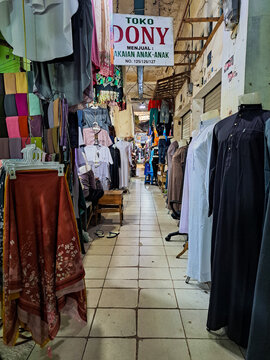 Barabai district, Indonesia, June 20th 2025, vibrant traditional market aisle in Indonesia, featuring various modest clothing items for men and women, including abayas and headscarves, displayed