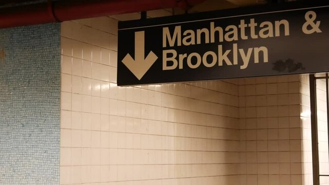 New York subway station interior, Manhattan text sign. Underground metropolitan. United States metro transport navigation. Information signage public passenger railway. Downtown and Brooklyn direction