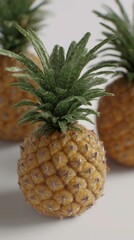 "Tropical Trio: A Natural Close-Up of Three Pineapples Showcasing Golden-Yellow Textured Skins and Crowned with Spiky Green Leaves — A Celebration of Exotic Flavor and Summer Freshness"