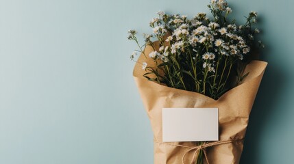 A beautifully arranged bouquet of fresh flowers wrapped in craft paper, accompanied by a blank card, an ideal symbol of love, thoughtfulness, and simple gestures of kindness.