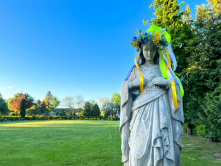 A figure of Mary with a wreath on her head in the garden at the Minor Basilica of Our Lady of...