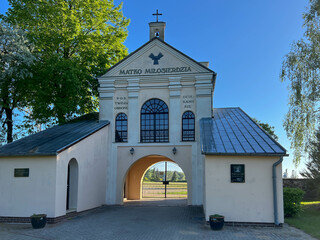 One of the gates to the garden at the Minor Basilica of Our Lady of Patiently Listening in Rokitno, Poland, leading to the parking lot