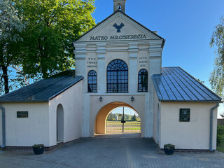 One of the gates to the garden at the Minor Basilica of Our Lady of Patiently Listening in Rokitno, Poland, leading to the parking lot