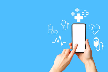 A hand interacts with a smartphone displaying health-related icons on a blue background