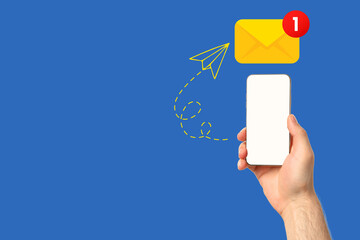 A hand is displaying a smartphone with a notification indicating a new message