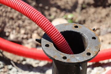 A pipe with a red hose sticking out