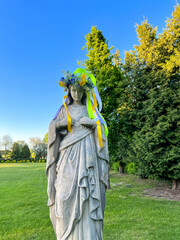 A figure of Mary with a wreath on her head in the garden at the Minor Basilica of Our Lady of Listening Patiently in Rokitno, Poland