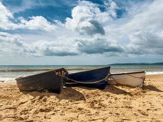 Fishing Boats Resting on the Sandy Shore in Dorset, England