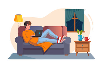 Obraz premium Man relaxing on sofa working on laptop at night