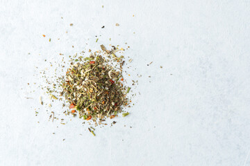 pile of mixed dried herbs on white background