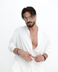 cool fashion man with glasses in white costume looking at camera
