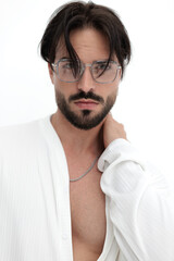 confident casual man in white shirt with glasses holding hand on neck