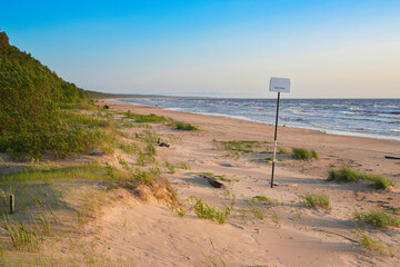 nude beach sign by the sea
