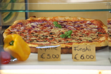 Fresh pizza ready for display with price tags in Euro, Italy