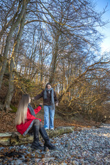 Two female friends on a walk in the forest. Friends walking through the forest. People in nature.