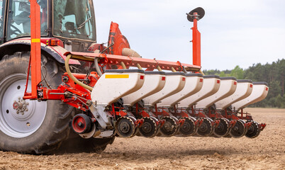 Precision inline seeder. A row seeder. Seed drill. Tractor with mounted seeder performing direct...