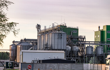 Large metallic silos store harvested grain, showcasing the industrial structure of a busy...
